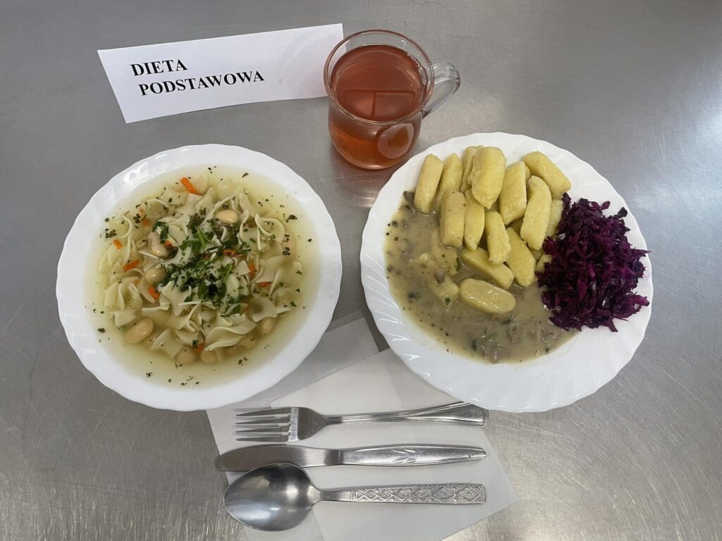 zdjęcie obiadu złożonego z: zupy fasolowej z makaronem, paluszków ziemniaczanych, sosu pieczarkowego oraz kompotu.
